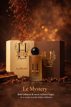 Perfume bottle and packaging with 'Le Mystery' fragrance on a warm, brown background.