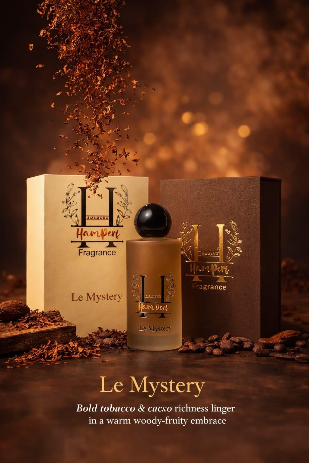 Perfume bottle and packaging with 'Le Mystery' fragrance on a warm, brown background.